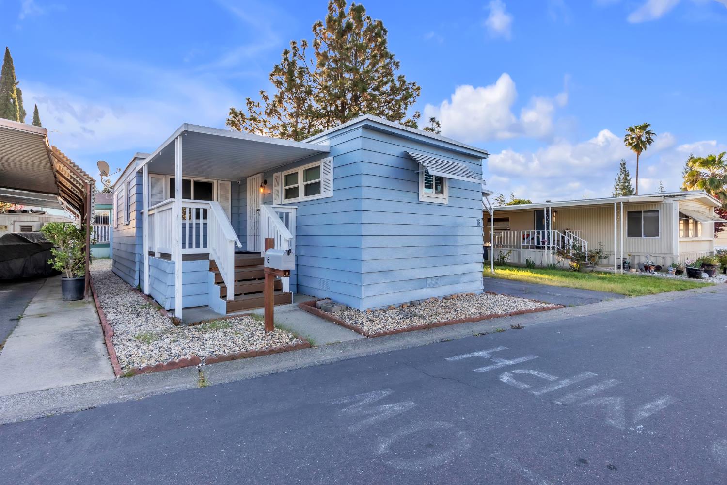 10035 Mills Station Road, Unit 16 Sacramento, CA 95827 - Photo 2 of 27 a view of a house with a yard and potted plants