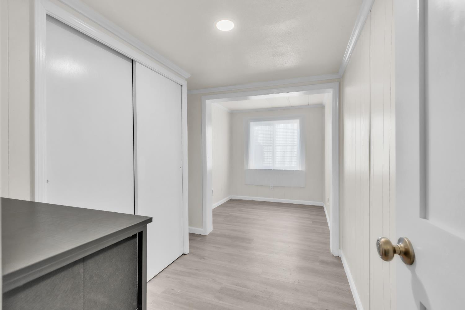 10035 Mills Station Road, Unit 16 Sacramento, CA 95827 - Photo 22 of 27 an empty room with wooden floor and windows