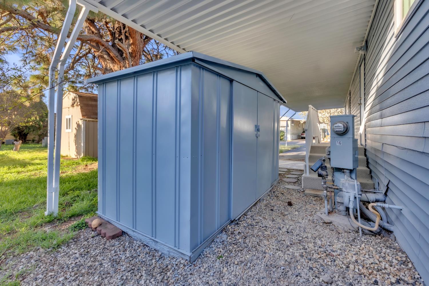 10035 Mills Station Road, Unit 16 Sacramento, CA 95827 - Photo 6 of 27 a backyard of a house with chairs and table in patio
