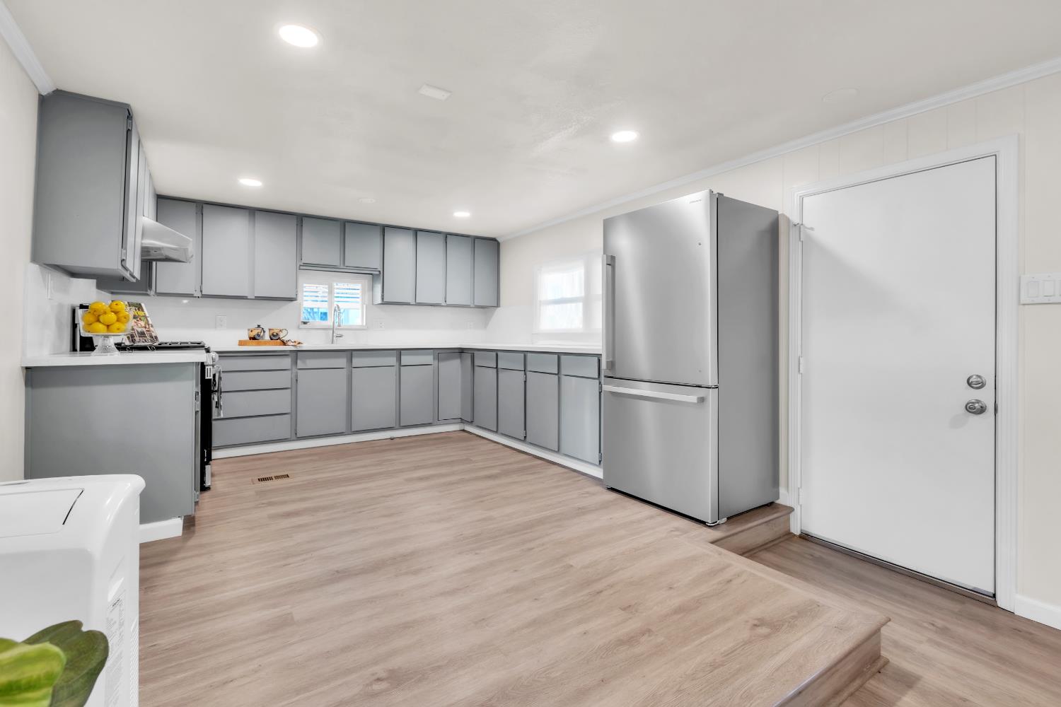 10035 Mills Station Road, Unit 16 Sacramento, CA 95827 - Photo 10 of 27 a kitchen with stainless steel appliances granite countertop a refrigerator and a stove top oven
