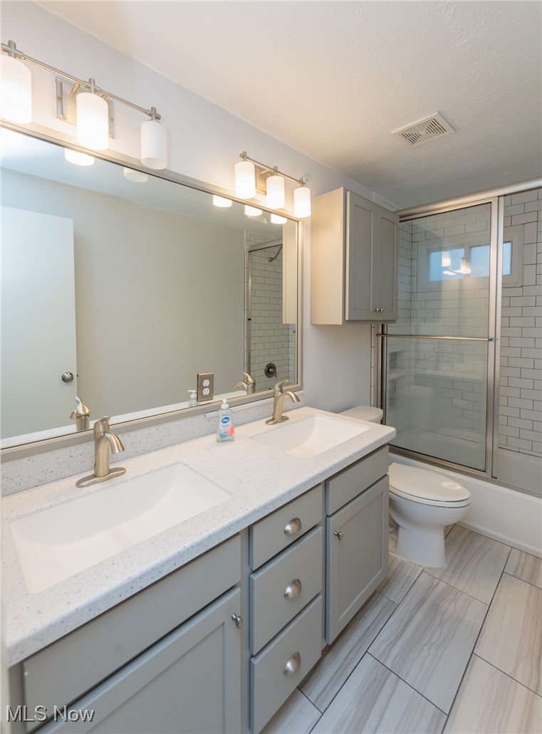 28013 Knickerbocker Road Bay Village, OH 44140 - Photo 22 of 38 Full bath with double vanity and enclosed tub / shower combo