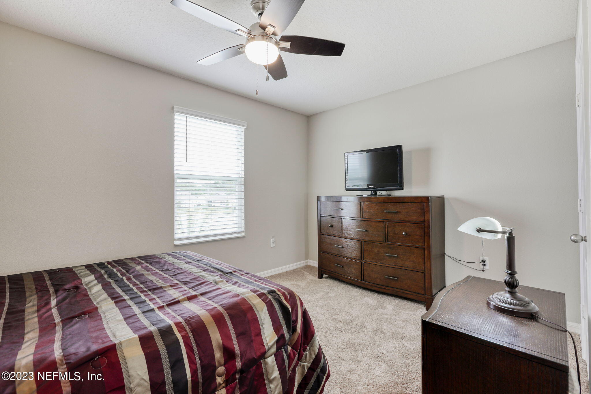 427 Falcon Ridge Road St. Augustine, FL 32084 - Photo 24 of 45 a bedroom with a bed and a flat screen tv