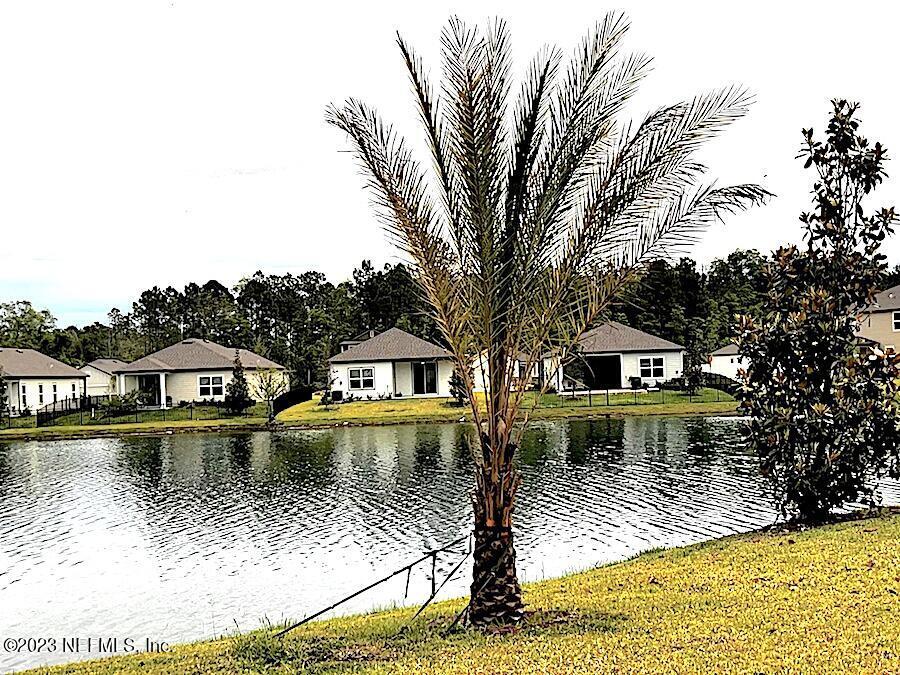 427 Falcon Ridge Road St. Augustine, FL 32084 - Photo 33 of 45 a view of a house with pool and chairs