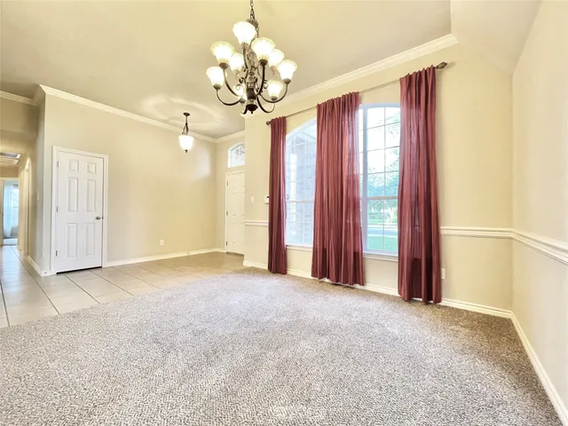 an empty room with fireplace and windows