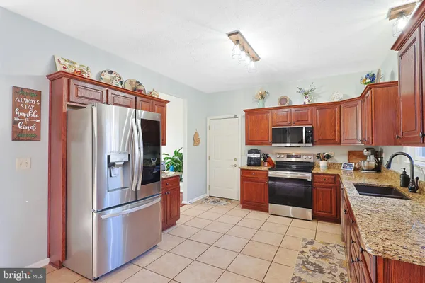 a living room with granite countertop furniture and a chandelier