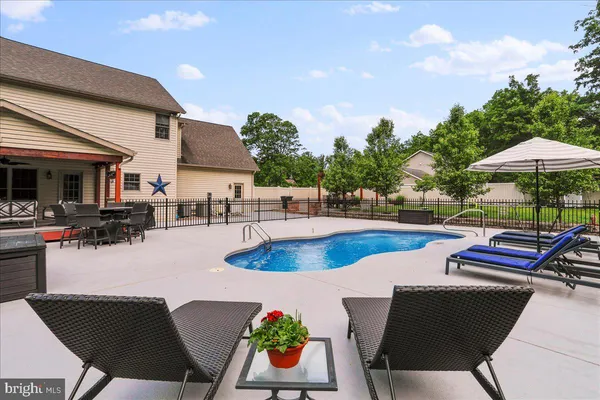 a view of a patio with swimming pool table and chairs
