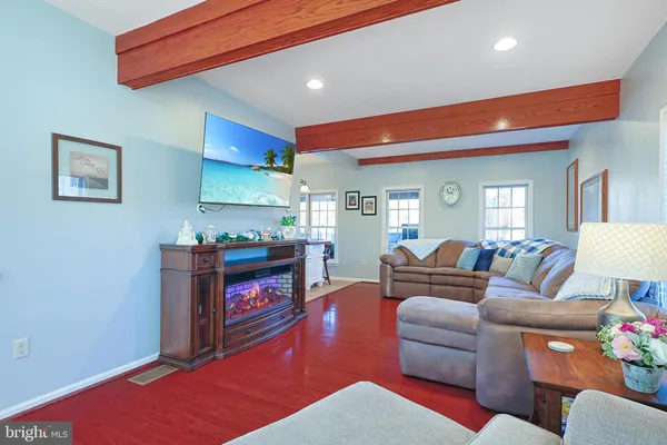 a living room with furniture kitchen view and a fireplace