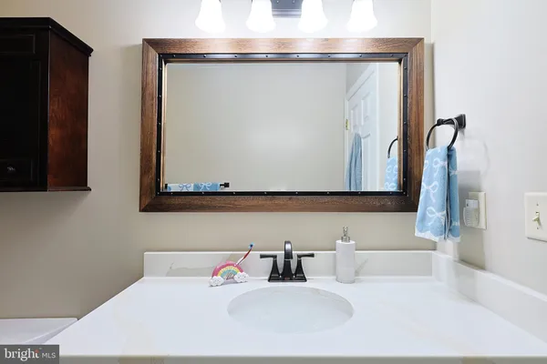 a bathroom with a sink a toilet and shower curtain