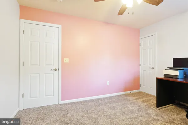 a view of a livingroom with workspace and a window