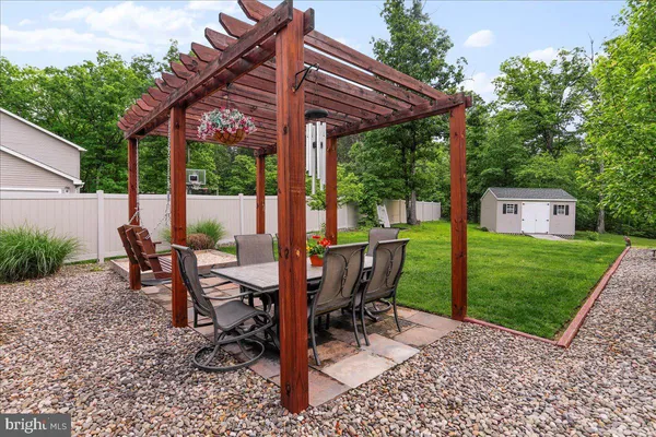 a view of a patio with a table chairs and a backyard