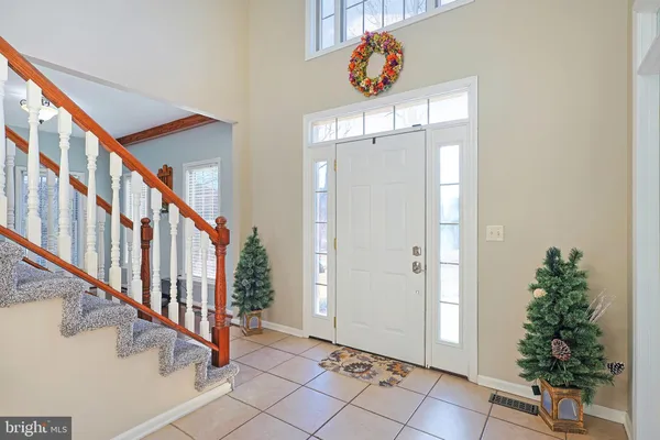 a view of an entryway with wooden floor and stairs