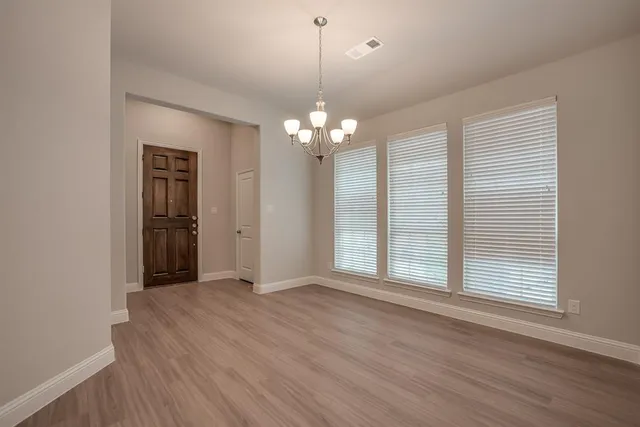 a kitchen with stainless steel appliances granite countertop a sink a refrigerator and a stove