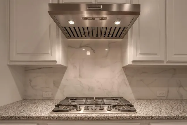 a kitchen with a sink a counter space and wooden floor