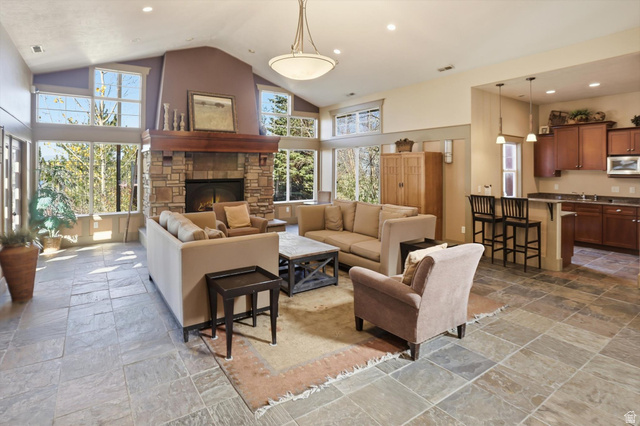 14820 175 East Draper, UT 84020 - Photo 37 of 39 Club house living area featuring high vaulted ceiling, recessed lighting, stone tile floors, and a fireplace