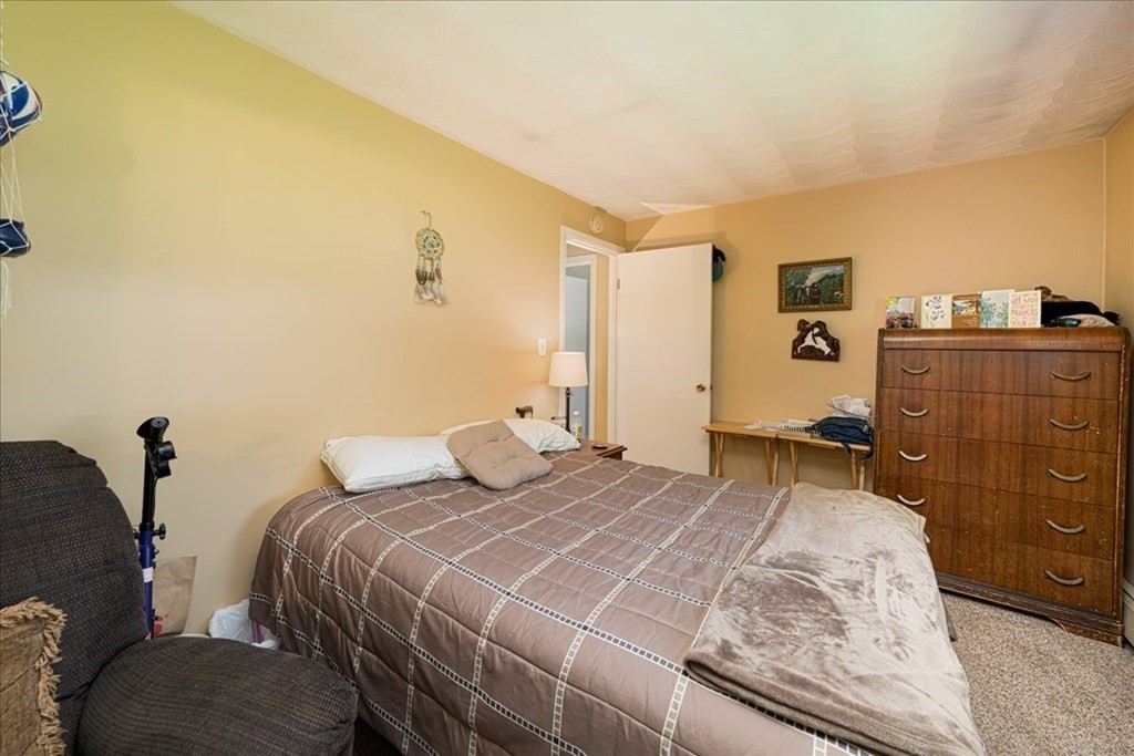 59 Eaton Road Framingham, MA 01701 - Photo 14 of 21 a bedroom with a bed and wooden floor