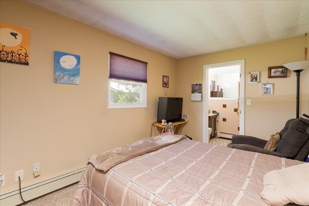 59 Eaton Road Framingham, MA 01701 - Photo 15 of 21 a bedroom with a bed and a flat tv screen on the dresser