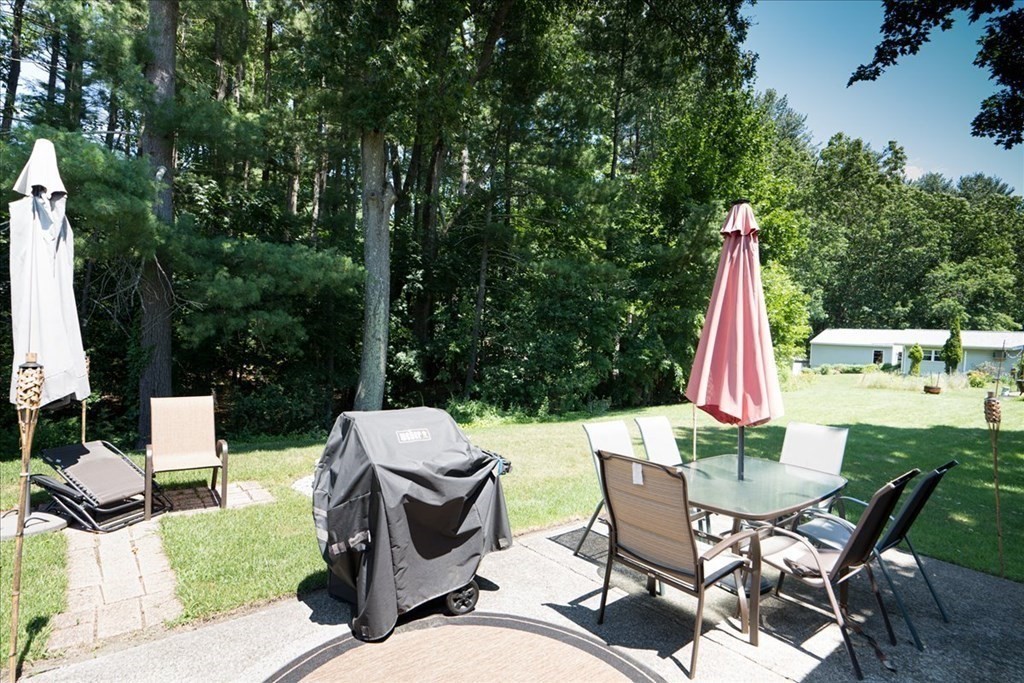 59 Eaton Road Framingham, MA 01701 - Photo 19 of 21 a view of a patio with table and chairs and wooden fence