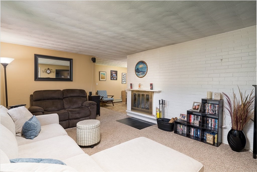59 Eaton Road Framingham, MA 01701 - Photo 3 of 21 a living room with furniture and a fireplace