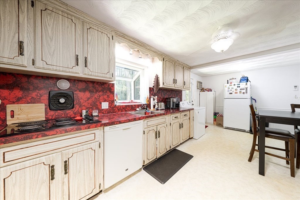 59 Eaton Road Framingham, MA 01701 - Photo 4 of 21 a kitchen with granite countertop white cabinets and white appliances