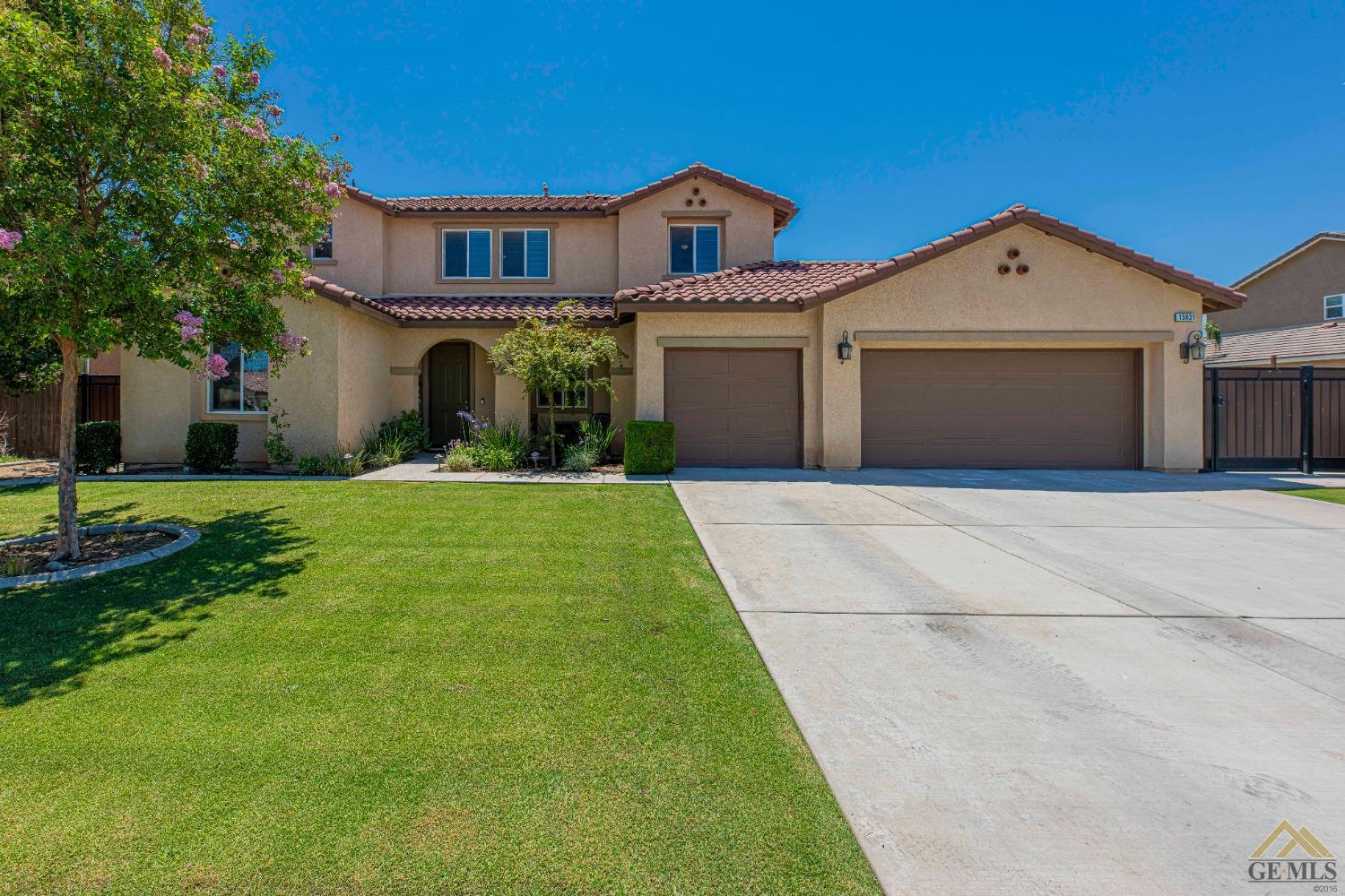 Undisclosed Address Bakersfield, CA 93314 - Photo 1 of 49 a front view of a house with a yard and garage