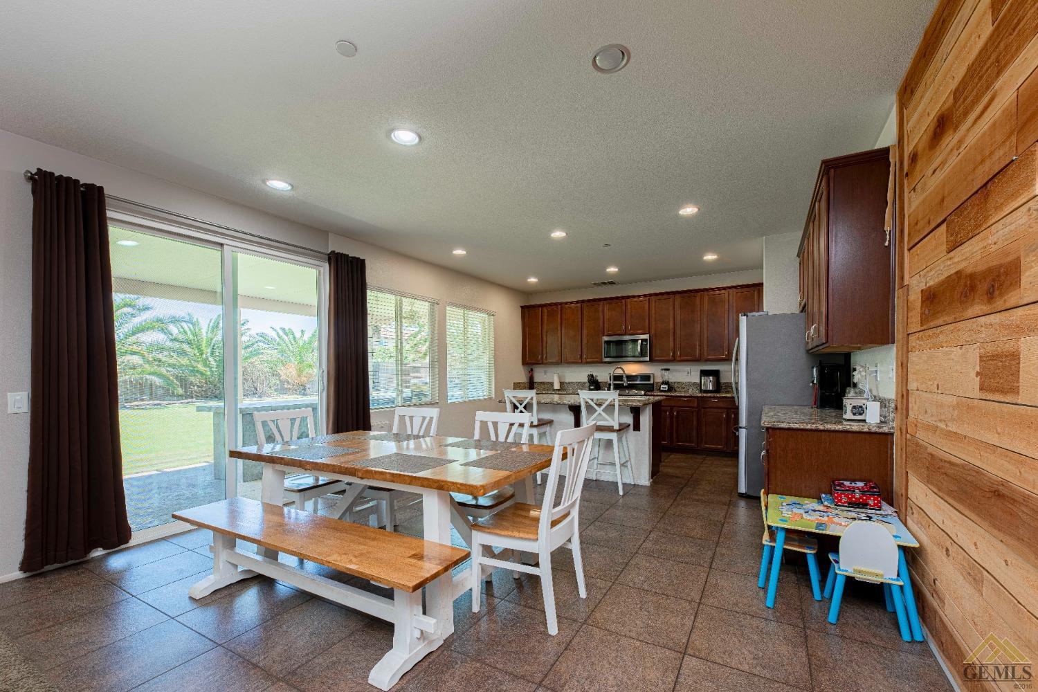 Undisclosed Address Bakersfield, CA 93314 - Photo 12 of 49 a dining room with furniture and a large window