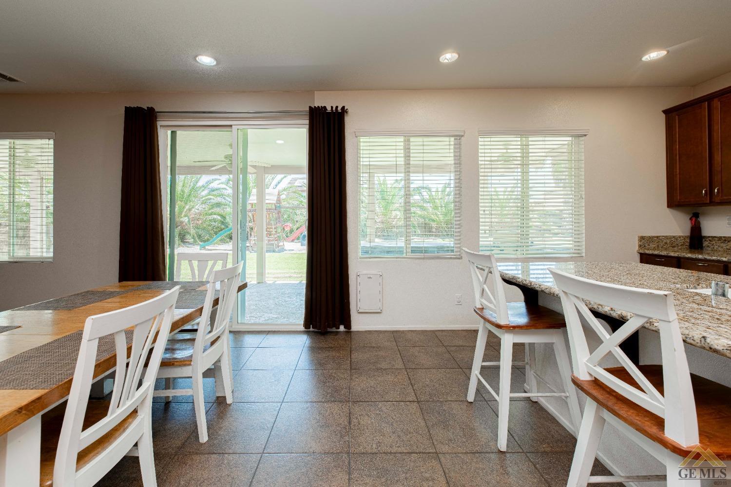 Undisclosed Address Bakersfield, CA 93314 - Photo 18 of 49 a dining room with furniture and a floor to ceiling window