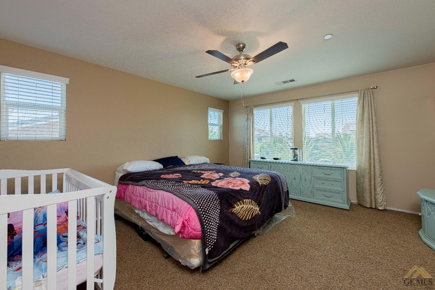 Undisclosed Address Bakersfield, CA 93314 - Photo 19 of 49 a bedroom with a bed and a window