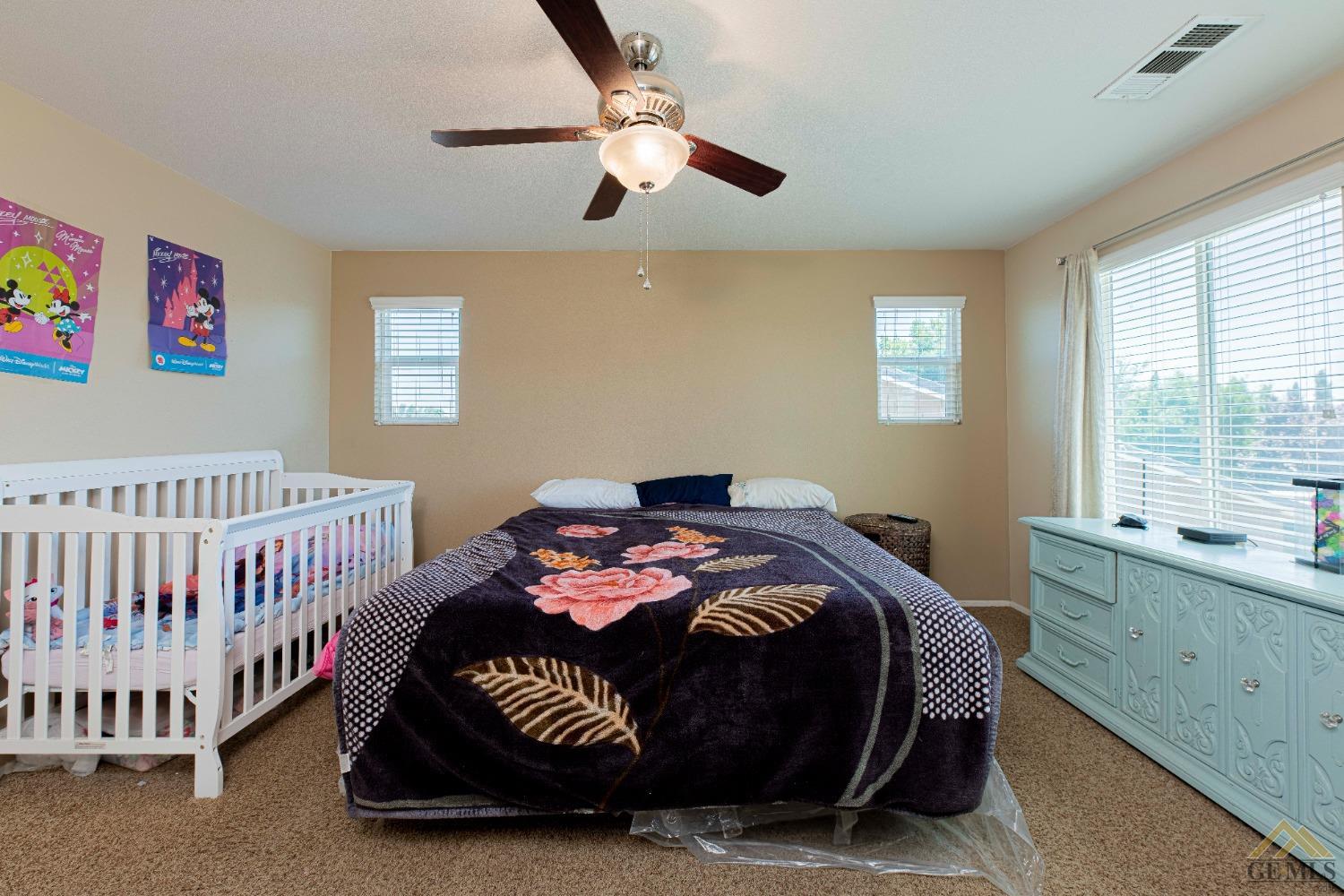 Undisclosed Address Bakersfield, CA 93314 - Photo 20 of 49 a bedroom with a bed and a window