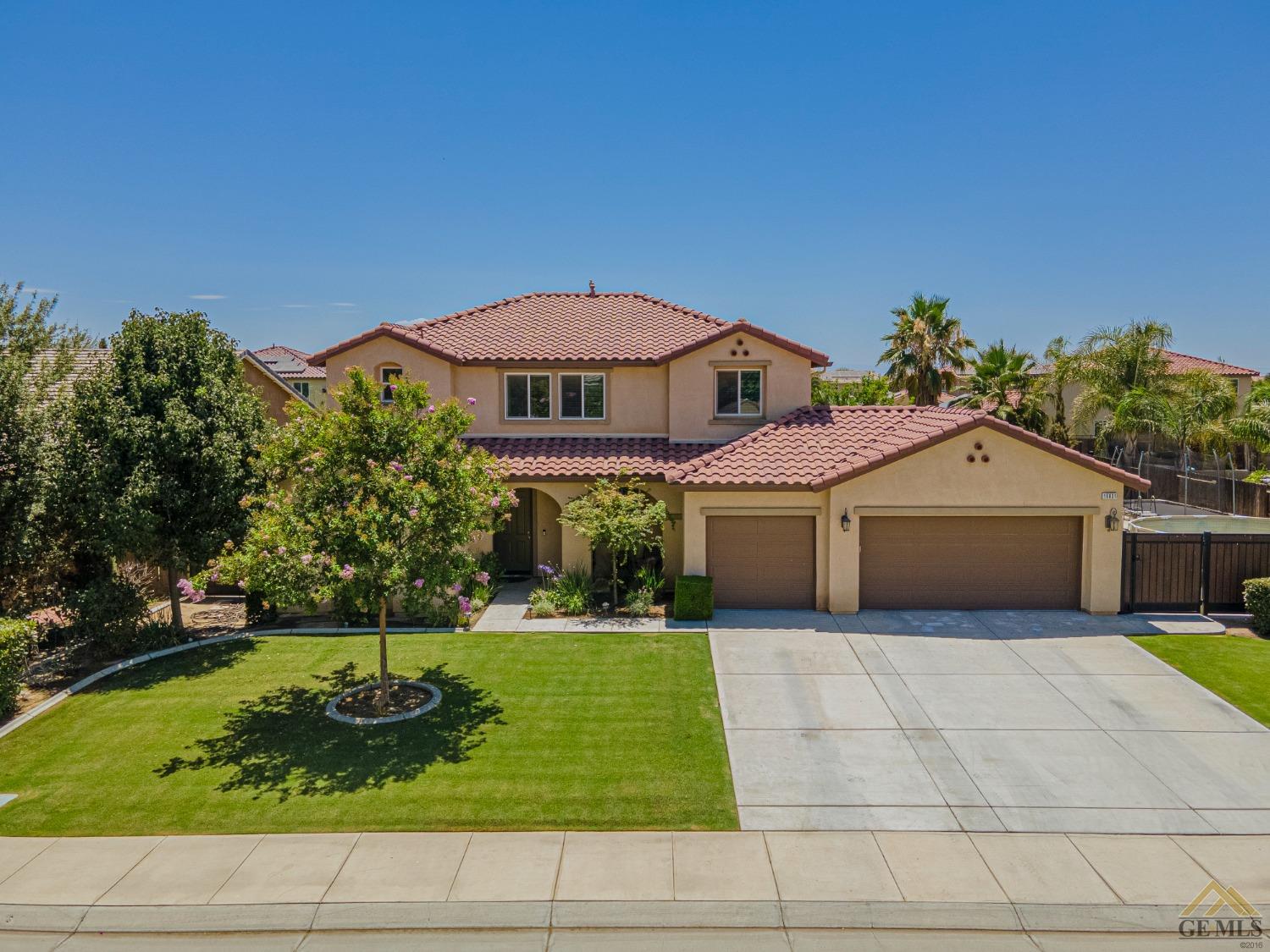 Undisclosed Address Bakersfield, CA 93314 - Photo 2 of 49 a front view of house with yard and trees in the background