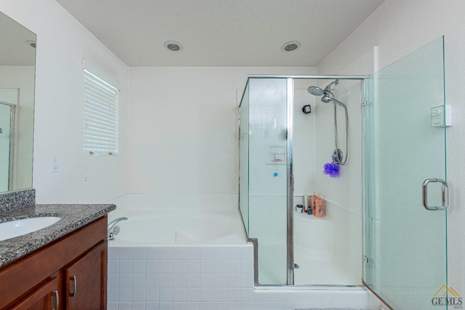 Undisclosed Address Bakersfield, CA 93314 - Photo 22 of 49 a bathroom with a shower and a sink