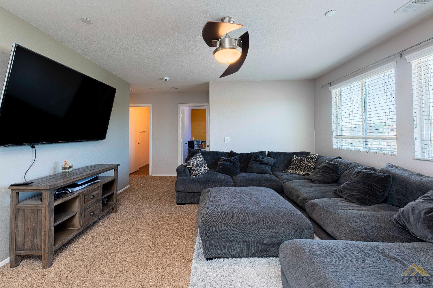 Undisclosed Address Bakersfield, CA 93314 - Photo 24 of 49 a living room with furniture and a flat screen tv