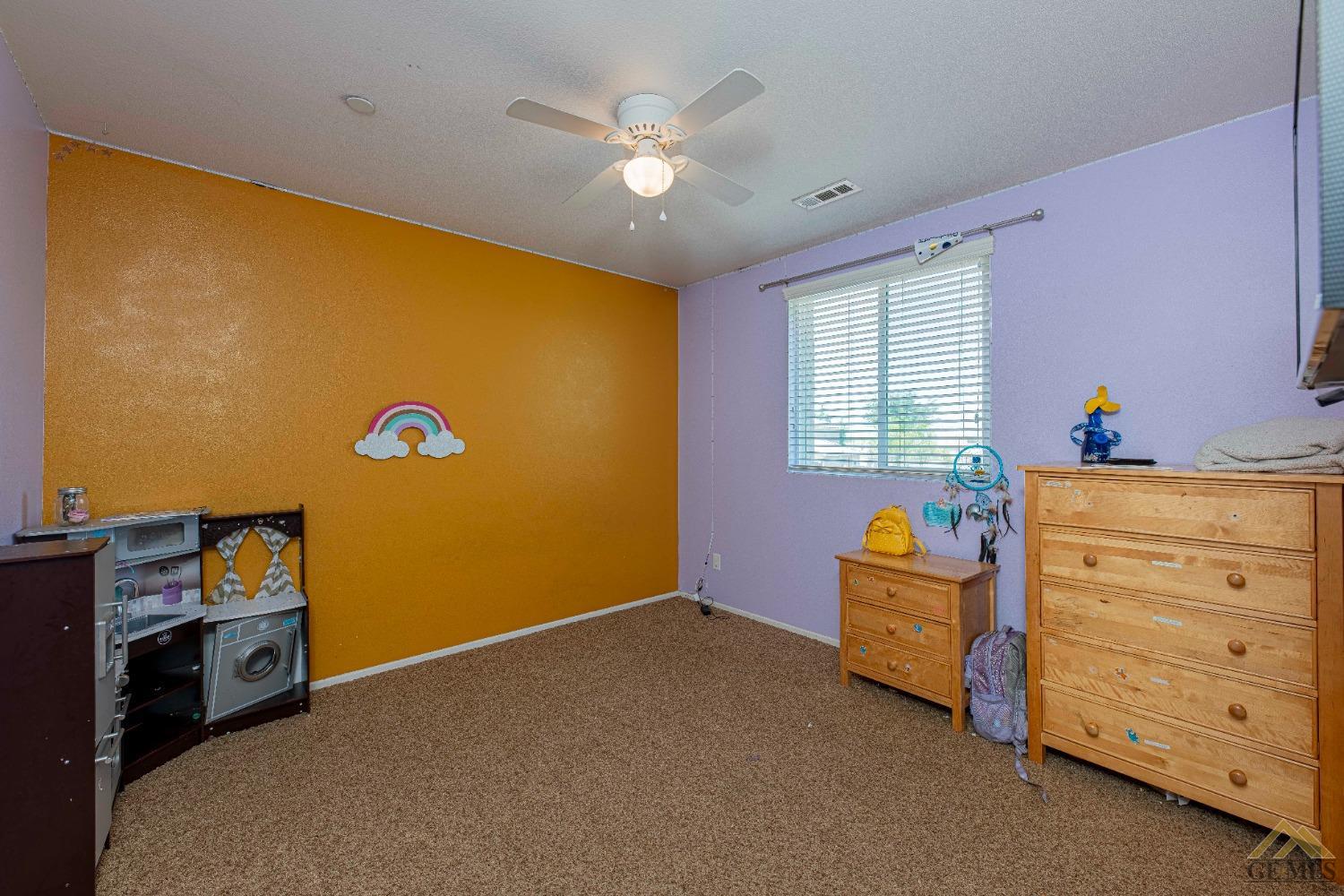 Undisclosed Address Bakersfield, CA 93314 - Photo 27 of 49 a bed room with a bed and a window