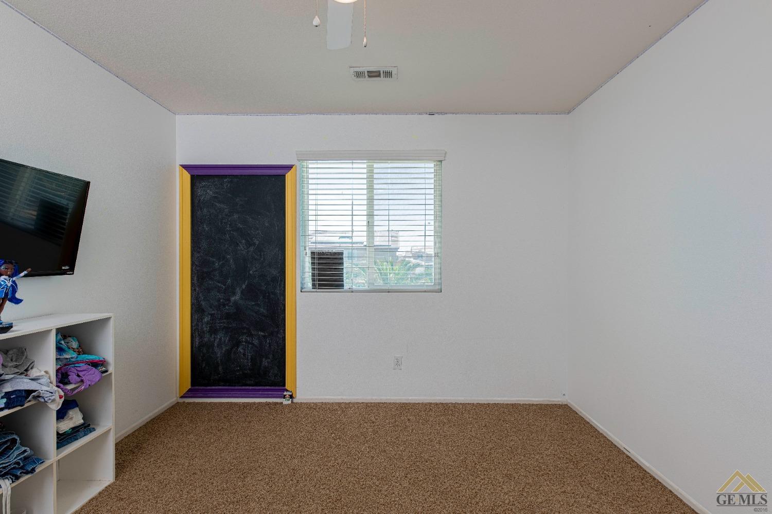 Undisclosed Address Bakersfield, CA 93314 - Photo 31 of 49 an empty room with flat screen tv and windows