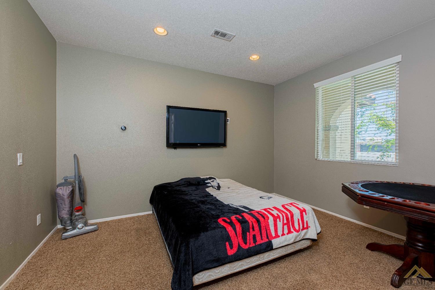 Undisclosed Address Bakersfield, CA 93314 - Photo 36 of 49 a bedroom with a bed and a flat screen tv