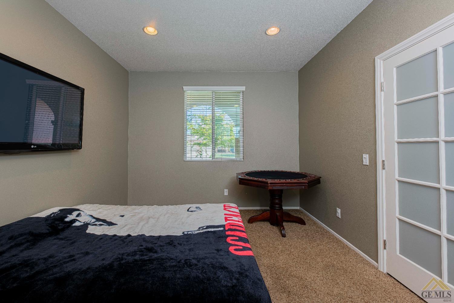 Undisclosed Address Bakersfield, CA 93314 - Photo 37 of 49 a bedroom with a bed and a window