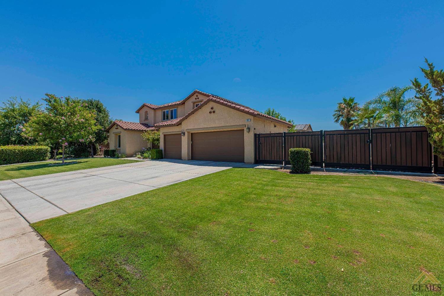 Undisclosed Address Bakersfield, CA 93314 - Photo 4 of 49 a front view of a house with a garden