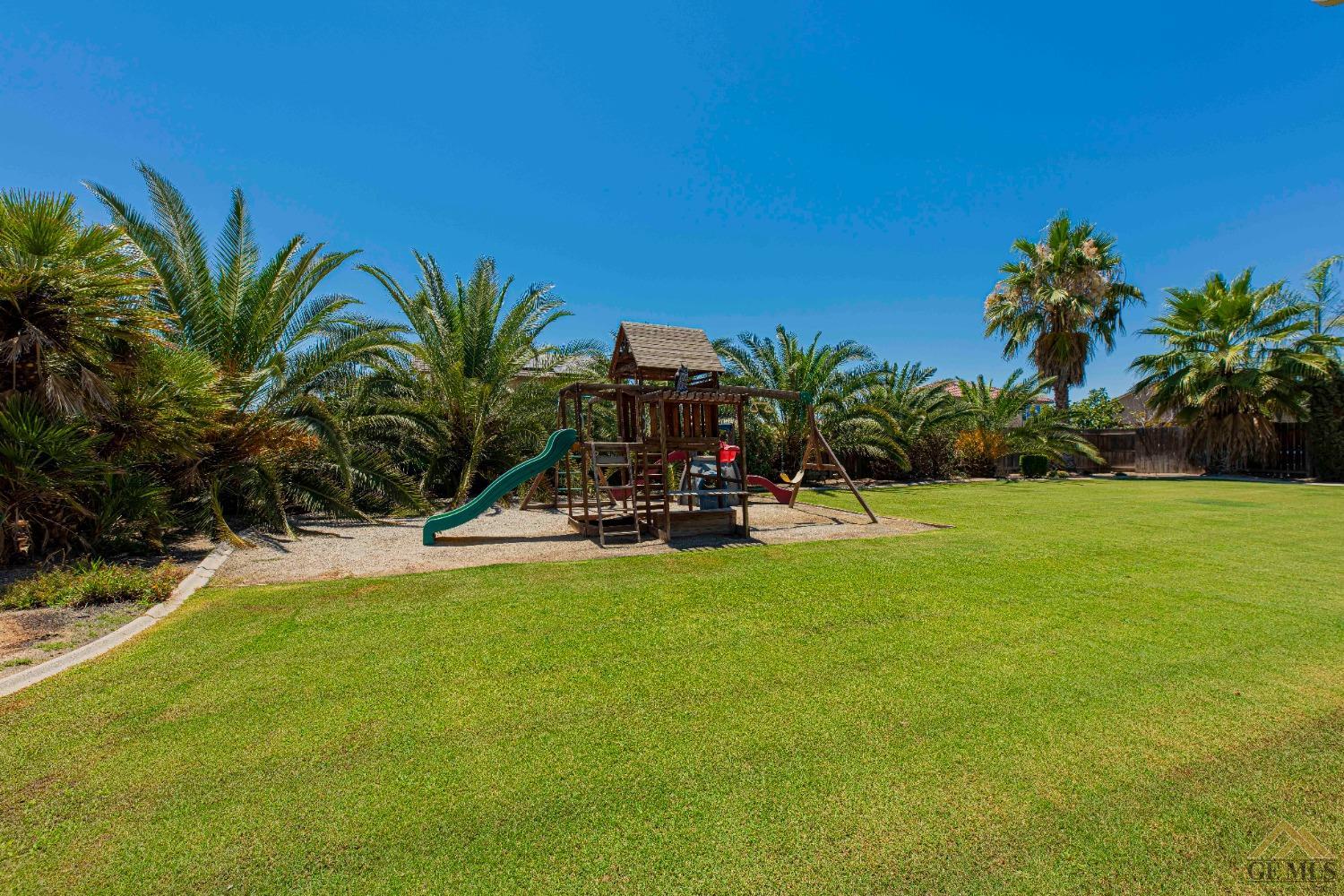 Undisclosed Address Bakersfield, CA 93314 - Photo 42 of 49 a view of a swimming pool with a table and chairs