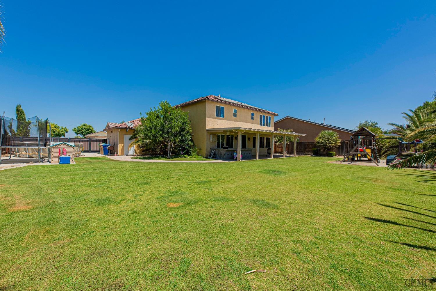 Undisclosed Address Bakersfield, CA 93314 - Photo 47 of 49 a front view of a house with a yard