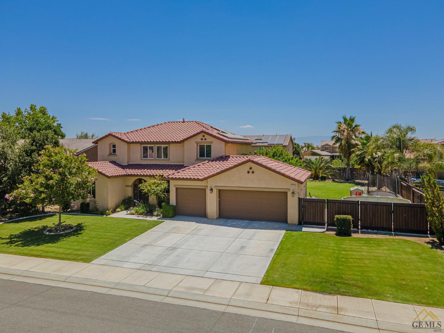 Undisclosed Address Bakersfield, CA 93314 - Photo 6 of 49 a front view of a house with a garden and yard