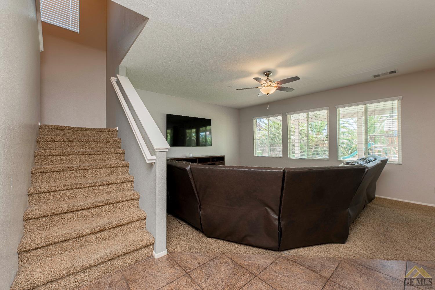 Undisclosed Address Bakersfield, CA 93314 - Photo 8 of 49 a living room with furniture and a ceiling fan