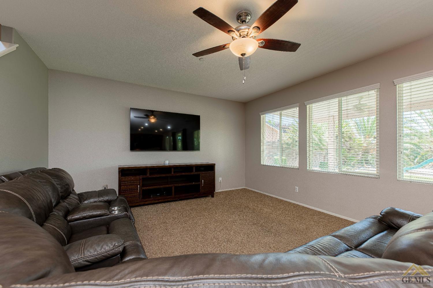 Undisclosed Address Bakersfield, CA 93314 - Photo 9 of 49 a living room with furniture a ceiling fan and a window
