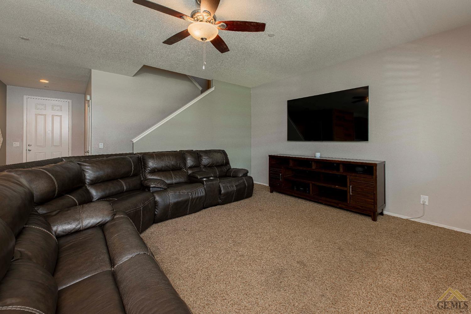 Undisclosed Address Bakersfield, CA 93314 - Photo 10 of 49 a living room with furniture and a flat screen tv