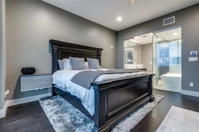 a bedroom with a bed and a mirror