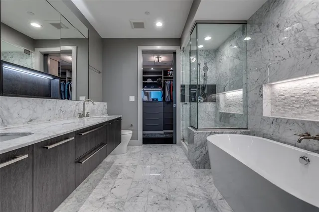 a bathroom with a tub sink shower and mirror
