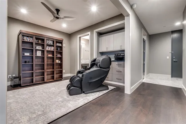 a living room with furniture and a ceiling fan