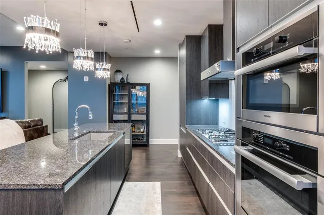 a kitchen with stainless steel appliances granite countertop a stove oven and a refrigerator