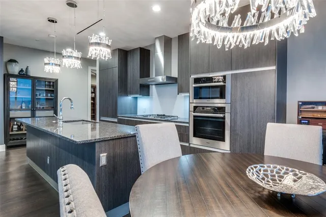 a kitchen with stainless steel appliances granite countertop a sink refrigerator and microwave