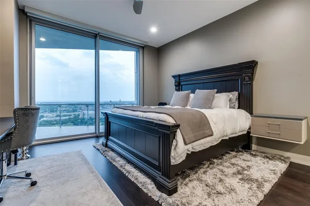 a bedroom with a bed and large window