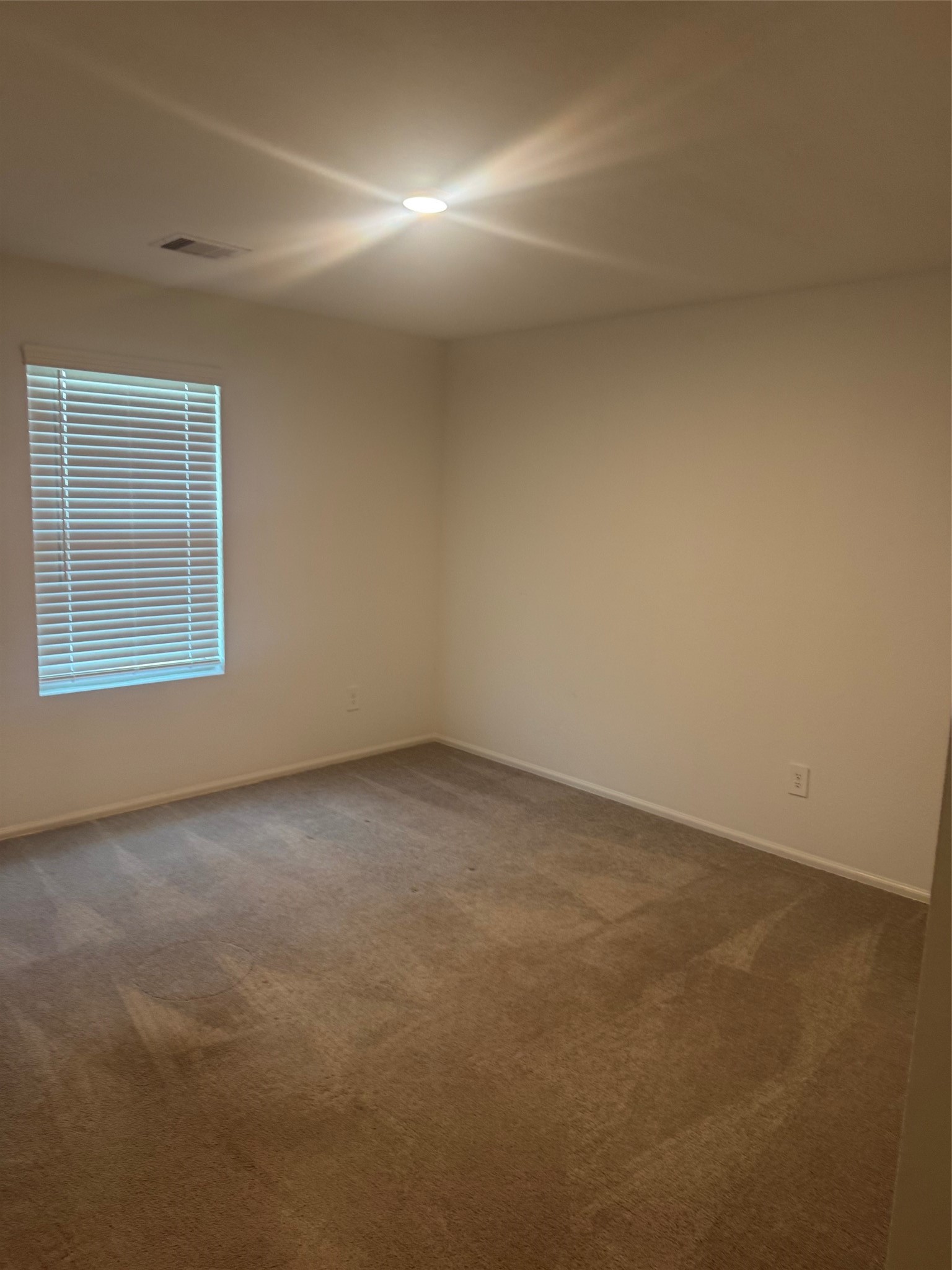 3202 Holly Stokes Way Conroe, TX 77301 - Photo 22 of 24 an empty room with a empty space and window