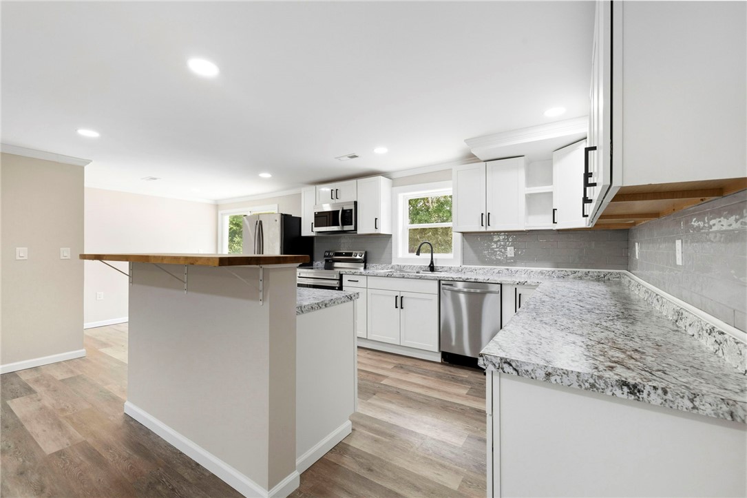 418 Old River Road Pelzer, SC 29669 - Photo 7 of 29 Clean lines and modern finishes define this kitchen, offering both elegance and everyday functionality.